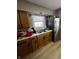 Functional kitchen equipped with wood cabinets, stainless steel appliances, and double sink at 3752 N Oxford St, Indianapolis, IN 46218
