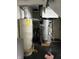 Utility area featuring a water heater and ventilation system, ensuring home comfort and functionality at 3752 N Oxford St, Indianapolis, IN 46218