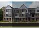 New townhome row with brick and vinyl siding, multi-pane windows, and contrasting trim at 412 Elite St # 2-601, Westfield, IN 46074