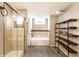 Bathroom with shower, separate soaking tub and floating wooden shelves at 4435 E 38Th St, Indianapolis, IN 46218