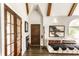 Inviting entryway with wood floors, beamed ceilings, seating, and a striking front door at 4435 E 38Th St, Indianapolis, IN 46218