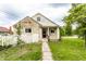 Charming home with stone facade, white picket fence, and well-manicured lawn at 4435 E 38Th St, Indianapolis, IN 46218