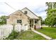 Classic home exterior featuring a stone facade, white trim, and verdant landscaping at 4435 E 38Th St, Indianapolis, IN 46218