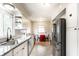 Modern kitchen with stainless steel appliances, white cabinetry, and tiled backsplash at 4435 E 38Th St, Indianapolis, IN 46218
