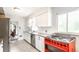 Well-lit kitchen featuring white cabinets, stainless appliances, gas range, and granite countertops at 4435 E 38Th St, Indianapolis, IN 46218