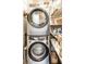 Efficient laundry area featuring a stackable washer and dryer with ample storage shelving at 4435 E 38Th St, Indianapolis, IN 46218