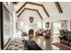 Spacious living room featuring beamed ceilings, hardwood floors, and a cozy fireplace at 4435 E 38Th St, Indianapolis, IN 46218