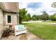 Charming home exterior featuring a cozy white bench, potted flowers, and landscaped lawn at 4435 E 38Th St, Indianapolis, IN 46218