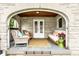 Inviting front porch with stone detailing, wicker furniture, and quaint seating area at 4435 E 38Th St, Indianapolis, IN 46218