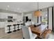 Dining area and kitchen featuring an island with barstools and stainless appliances at 4512 Laughter Ln, Indianapolis, IN 46235