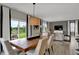 Open dining area with a wooden table, elegant chairs, and natural light at 4512 Laughter Ln, Indianapolis, IN 46235