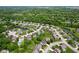 An aerial view of a residential neighborhood featuring mature trees and a pond with a fountain at 4681 Shelby Cir, Greenwood, IN 46143