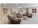 The basement is carpeted and features plenty of seating, as well as a ping pong table at 4681 Shelby Cir, Greenwood, IN 46143