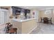 Basement bar with granite countertops, dark cabinetry, and seating for entertaining at 4681 Shelby Cir, Greenwood, IN 46143