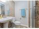 Bathroom with white pedestal sink, toilet, framed mirror, and stand up shower at 4681 Shelby Cir, Greenwood, IN 46143