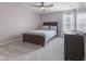 This bedroom features carpet, a ceiling fan, neutral paint, and a wood bed frame with plenty of natural light at 4681 Shelby Cir, Greenwood, IN 46143