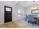Bright dining room showcasing modern chandelier, wood table, blue upholstered chairs, and wood floors at 4681 Shelby Cir, Greenwood, IN 46143
