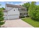 Charming two-story home featuring a three-car garage, front porch and manicured lawn at 4681 Shelby Cir, Greenwood, IN 46143
