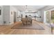 Bright kitchen and dining area with white cabinetry, modern lighting, and stainless steel appliances at 4681 Shelby Cir, Greenwood, IN 46143