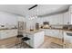 Modern kitchen featuring white cabinets, granite countertops, stainless steel appliances, and an island with bar stool seating at 4681 Shelby Cir, Greenwood, IN 46143