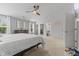 Bright main bedroom with a ceiling fan, neutral walls, and an ensuite bathroom entrance at 4681 Shelby Cir, Greenwood, IN 46143