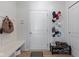 Well-organized mudroom featuring a bench, coat hooks, shoe storage, and easy access to the garage and house at 4681 Shelby Cir, Greenwood, IN 46143