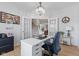 Bright office with French doors, stylish chandelier, white desk, and wood floors at 4681 Shelby Cir, Greenwood, IN 46143