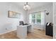 Bright office featuring a sleek white desk, modern chandelier, and wood flooring at 4681 Shelby Cir, Greenwood, IN 46143