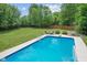 Inviting backyard pool with diving board and basketball hoop for outdoor enjoyment at 4681 Shelby Cir, Greenwood, IN 46143