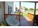 Relaxing back porch with wooden deck, outdoor seating, and a view of the fenced-in yard and pool at 5101 W Bay Rd, Plainfield, IN 46168