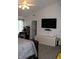 Bright bedroom featuring a large TV, ceiling fan, and neutral decor for a calming atmosphere at 5101 W Bay Rd, Plainfield, IN 46168