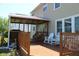 Spacious wooden deck featuring a covered area and comfortable seating with great backyard views at 5101 W Bay Rd, Plainfield, IN 46168