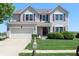 Charming two-story home with attached garage, well-manicured lawn, and inviting curb appeal at 5101 W Bay Rd, Plainfield, IN 46168