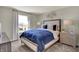Comfortable bedroom with a large bed, neutral tones, and a view through the bright window at 5264 Summerton St, McCordsville, IN 46055