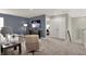 Cozy living room with blue accent wall, comfortable seating, and carpeted floor at 5264 Summerton St, McCordsville, IN 46055