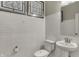 Elegant powder room featuring subway tile walls, a modern toilet, and a pedestal sink at 5267 Summerton St, McCordsville, IN 46055