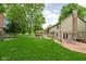 Expansive backyard featuring a wooden deck, playset, and lush green lawn for outdoor enjoyment at 5412 Green Hills Dr, Brownsburg, IN 46112