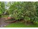 Gorgeous backyard featuring a large deck, patio set and landscaping, perfect for outdoor entertaining at 5412 Green Hills Dr, Brownsburg, IN 46112