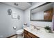Cozy half bathroom featuring a toilet, decorative mirror and sink at 5412 Green Hills Dr, Brownsburg, IN 46112
