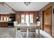 Inviting dining room open to kitchen, with white table and chairs perfect for Gathering gatherings at 5412 Green Hills Dr, Brownsburg, IN 46112