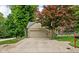 Attached two-car garage with concrete driveway, manicured lawn and landscaping at 5412 Green Hills Dr, Brownsburg, IN 46112