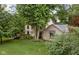 Two-story home featuring mature trees and a spacious yard with lush lawn and landscape design at 5412 Green Hills Dr, Brownsburg, IN 46112