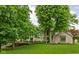 Two-story home boasts lush lawn and mature trees adding privacy and curb appeal to this beautiful property at 5412 Green Hills Dr, Brownsburg, IN 46112
