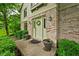 Inviting home entrance showcasing brick facade, decorative wreath, and manicured shrubs enhancing the curb appeal at 5412 Green Hills Dr, Brownsburg, IN 46112