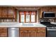 Bright kitchen with stainless steel appliances, double basin sink, and a charming window over the sink at 5412 Green Hills Dr, Brownsburg, IN 46112