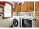 Convenient laundry room with modern washer and dryer, built-in cabinets, and natural light at 5412 Green Hills Dr, Brownsburg, IN 46112
