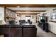 Spacious living room features brick fireplace, beamed ceiling, and plush furniture for cozy gatherings at 5412 Green Hills Dr, Brownsburg, IN 46112