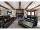 Comfortable living room boasts a brick fireplace, beamed ceilings, and stylish furniture creating a relaxing atmosphere at 5412 Green Hills Dr, Brownsburg, IN 46112