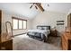 Spacious primary bedroom with vaulted ceiling, large windows, and plush carpeting for ultimate comfort at 5412 Green Hills Dr, Brownsburg, IN 46112