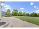 Expansive backyard featuring a stone fireplace and a large, patterned concrete patio for outdoor entertaining at 543 Amersham Ct, Avon, IN 46123